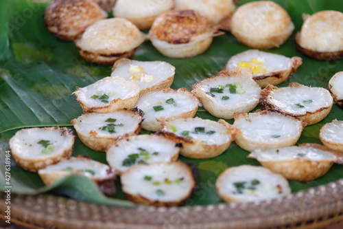 A traditional Thai dessert made from flour mixed with sugar and coconut milk placed on banana leaves.
