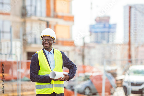 Male construction engineer. Architect with a tablet computer at a construction site. Young Man looking, building site place on background. Construction concept