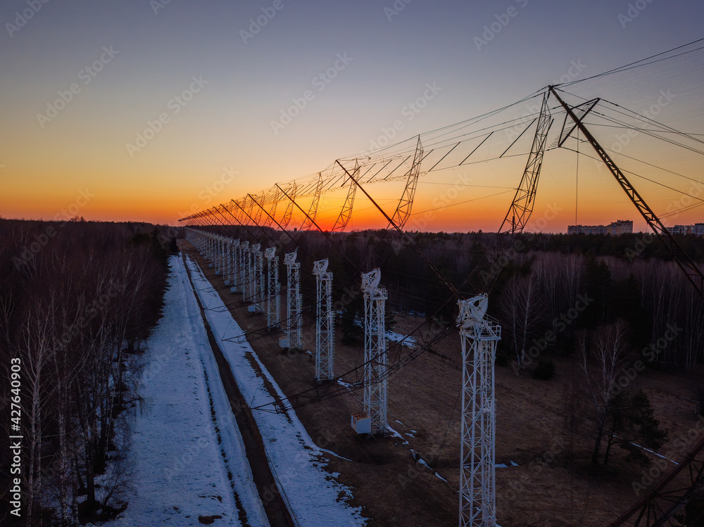 Antenna Array. A long row of radio telescopic antennas at the sunset
