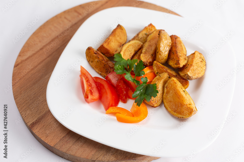 plate of roasted potatoes and fried meatballs on white background plate of roasted potatoes and fried meatballs on white background