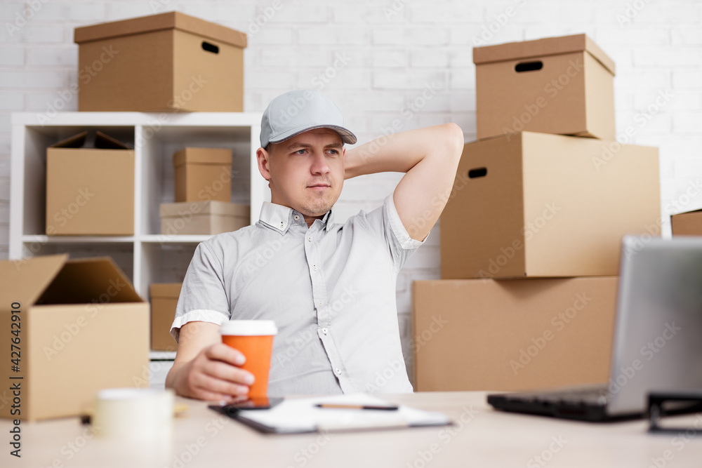 work and business concept - tired postman resting in workplace with coffee. work and business concept - tired postman resting in workplace with coffee.