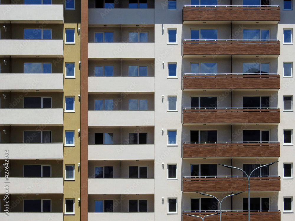 Exterior of a new modern high-rise condominium apartment building with balconies and lodges Exterior of a new modern high-rise condominium apartment building with balconies and lodges