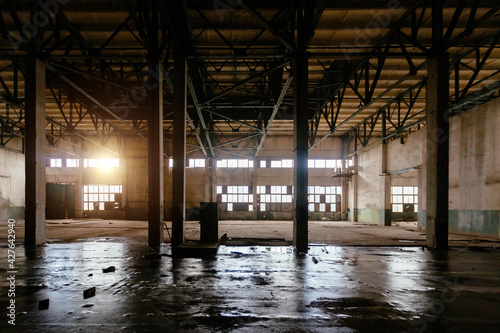 Old abandoned large industrial hall. Empty warehouse photo