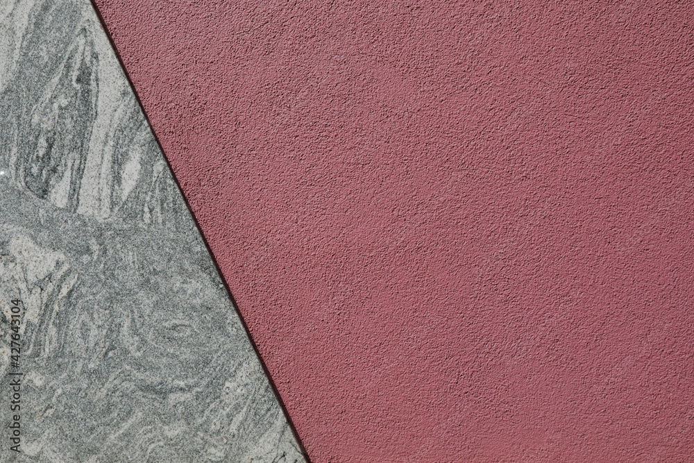 Fototapeta premium red wall divided with marble stone, abstract background with space for text, no person