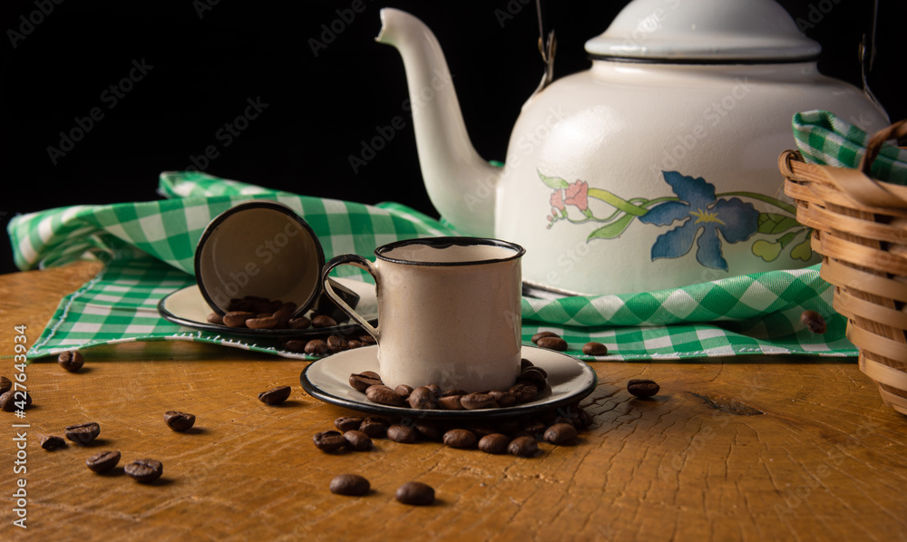 coffee table in Brazil in details with cups, coffee beans and cheese bread on rustic wood, with green and white checkered tablecloth, selective focus. coffee table in Brazil in details with cups, coffee beans and cheese bread on rustic wood, with green and white checkered tablecloth, selective focus.