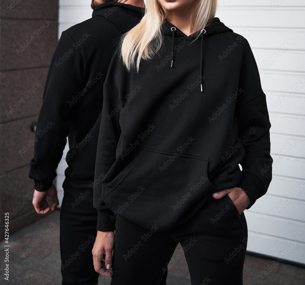 Woman and man wear black hoodie without a logo. No logo basic sportswear.  Long sleeve sweatshirt mockup Photos | Adobe Stock
