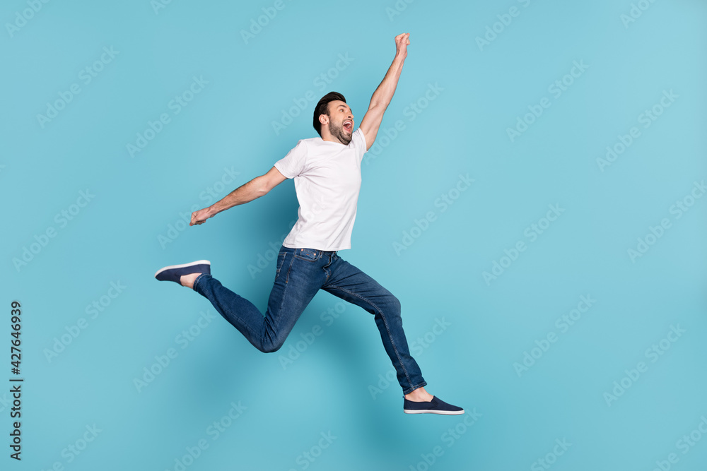 Full body profile photo of impressed person open mouth raise arm look empty space isolated on blue color background