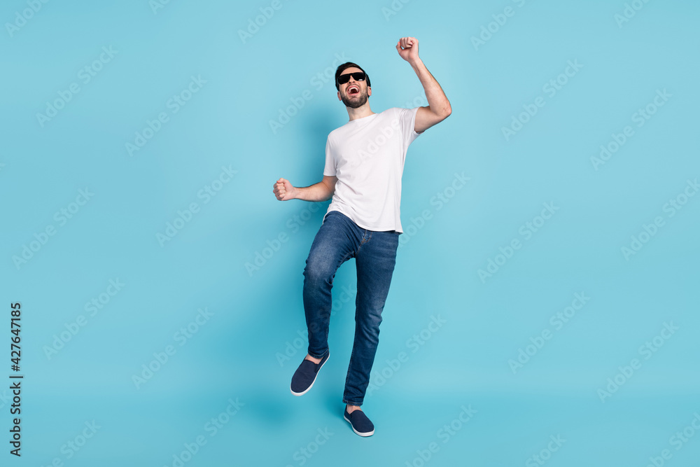 Full body portrait of crazy positive man dancing open mouth smile isolated on pastel blue color background Full body portrait of crazy positive man dancing open mouth smile isolated on pastel blue color background
