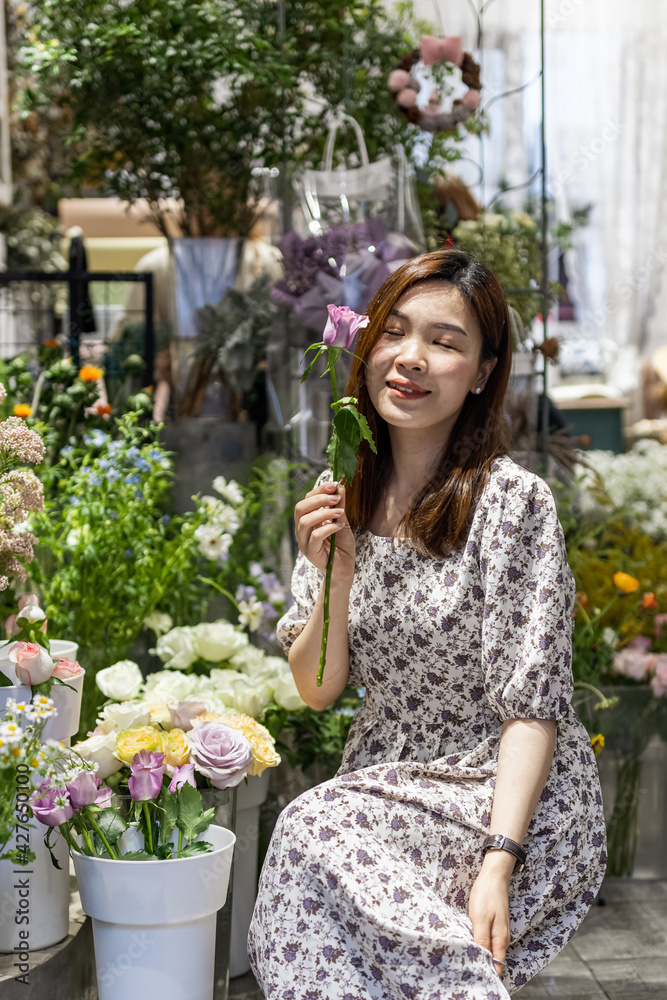 Startup successful small business entrepreneur owner young asian woman standing with flowers at florist shop