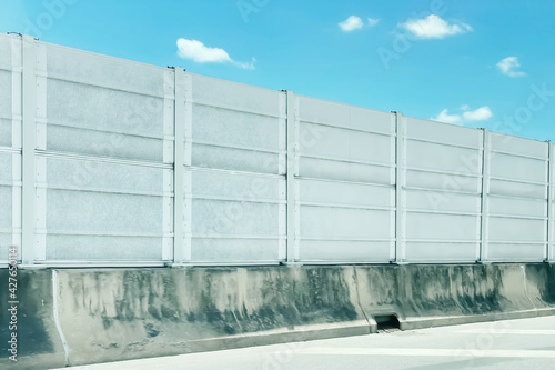 Sound barrier control wall image for control and protection lound noise from traffic on expressway with freshness morning summer blue sky and cloud background. photo
