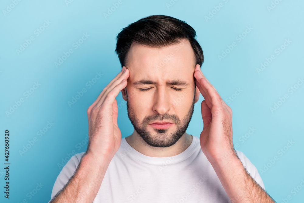 Close-up portrait of attractive depressed desperate guy feeling bad terrible headache isolated over blue bright pastel color background Close-up portrait of attractive depressed desperate guy feeling bad terrible headache isolated over blue bright pastel color background