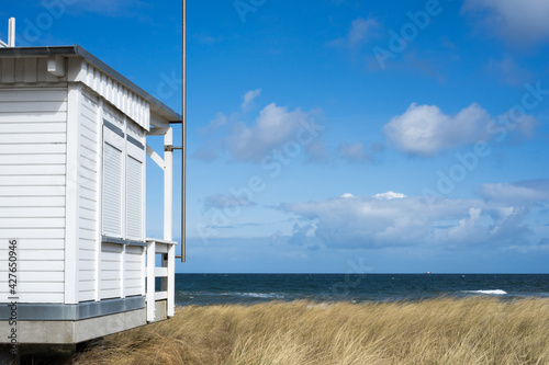 scene with the official Baywatch house made of white wood, golden dune grass, sea and blue sky, Mecklenburg, East Germany, Baltic Sea