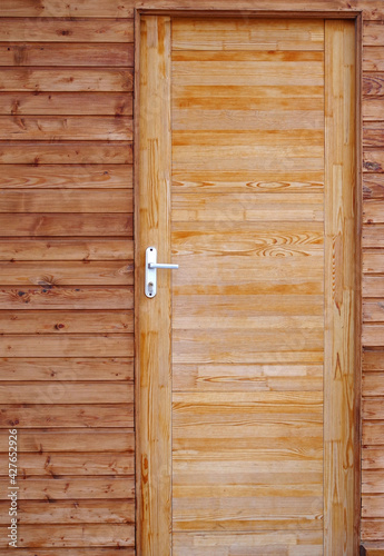 Brown wooden closed door © AVD