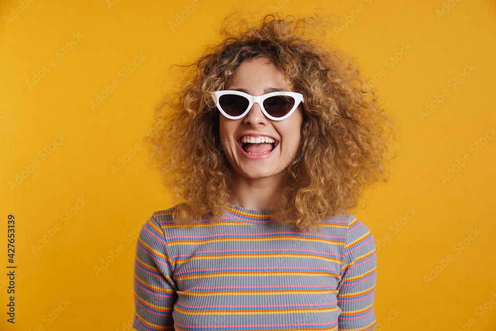 Happy young casual woman with fizzy hairstyle standing Happy young casual woman with fizzy hairstyle standing