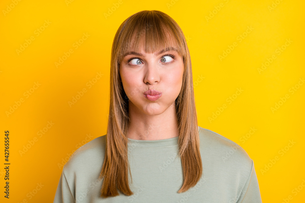 Close-up portrait of nice attractive crazy stupid girl having fun grimacing isolated over bright yellow color background Close-up portrait of nice attractive crazy stupid girl having fun grimacing isolated over bright yellow color background