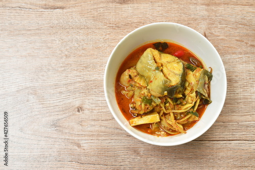 spicy boiled bamboo shoot with slice catfish in coconut milk and curry on bowl