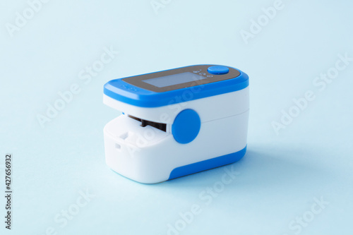 Pulse Oximeter, finger digital device to measure person's oxygen saturation. Reduced oxygenation is an emergency sign of pneumonia caused by flu or novel coronavirus.