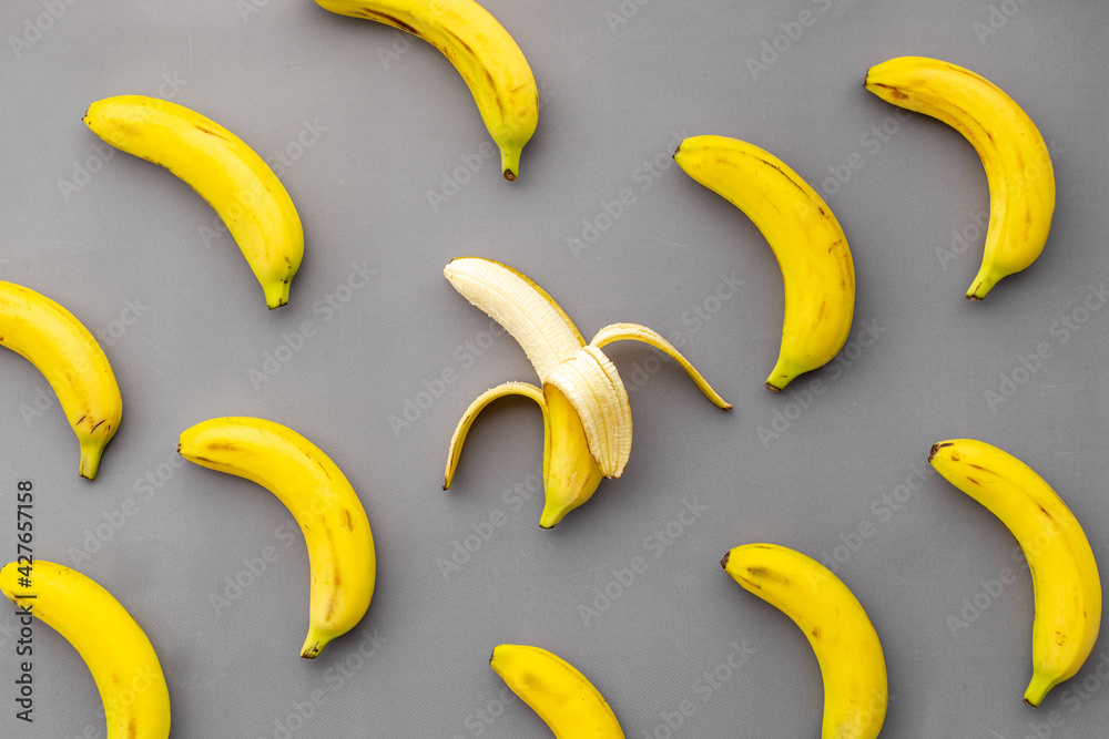 Whole and peeled bananas flay lay. Fruits pattern. Top view Whole and peeled bananas flay lay. Fruits pattern. Top view