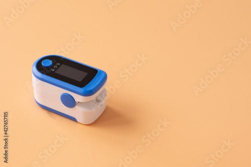 Pulse Oximeter, finger digital device to measure person's oxygen saturation. Reduced oxygenation is an emergency sign of pneumonia caused by flu or novel coronavirus.