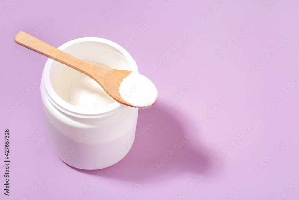 collagen in a white jar, wooden spoon, purple background, hard light collagen in a white jar, wooden spoon, purple background, hard light