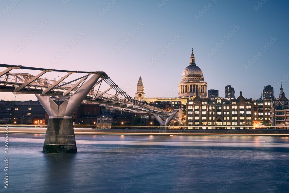 London cityscape at dusk. City waterfront with 
Millennium Footbridge against St. Pauls Cathedral.