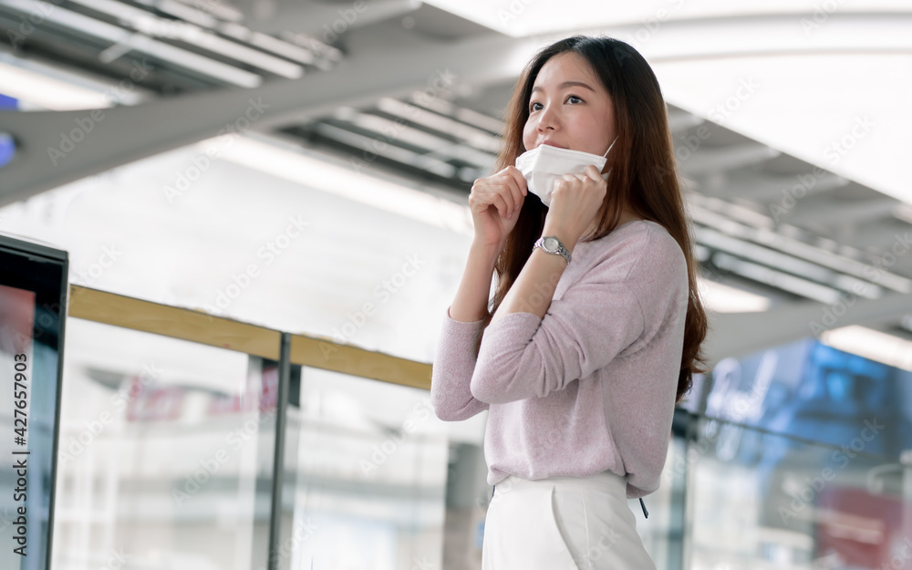 Asian beautiful long brown hair woman wearing casual shirt, face mask protecting virus pandemic, standing and waiting train at railway platform. Asian beautiful long brown hair woman wearing casual shirt, face mask protecting virus pandemic, standing and waiting train at railway platform.