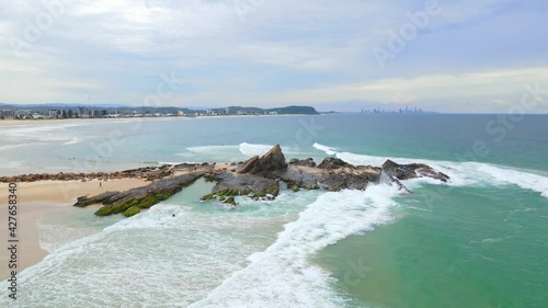 Currumbin Rock At Currumbin Beach With Rolling Waves From Coral Sea - Gold Coast, Queensland, Australia. - aerial photo