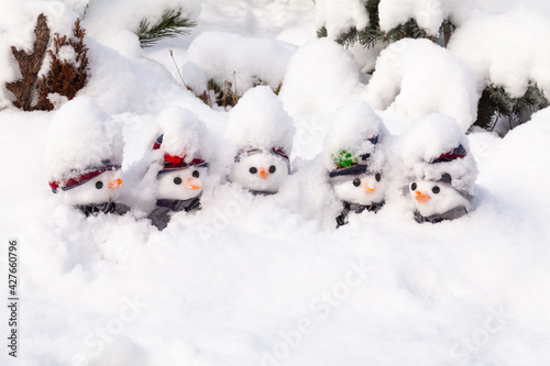 Five snowmen stick in a snow storm