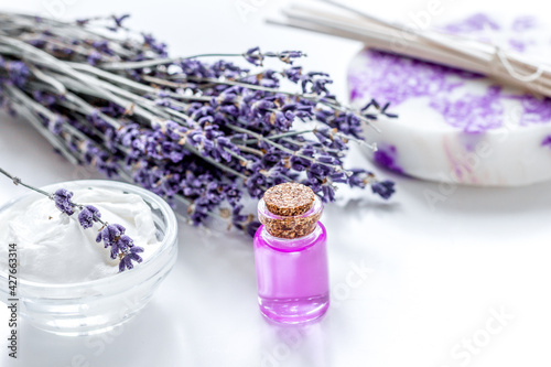 lavender herbs in body care cosmetics with oil on white table background