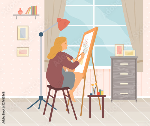 Girl sits and paints on canvas with brush. Woman near easel lamp and table with paints and brushes