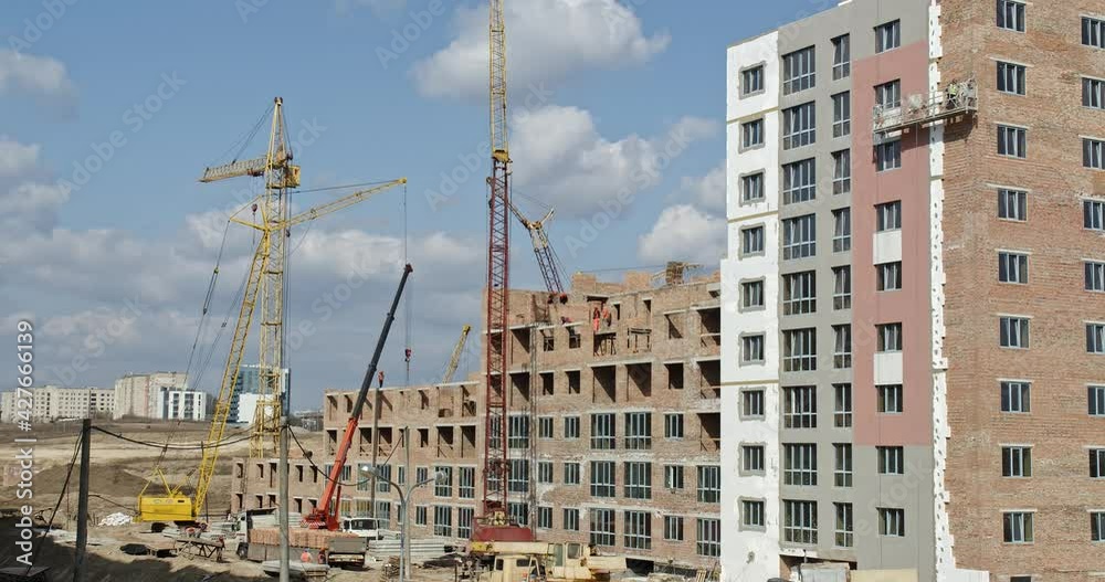 Tower Crane on a Construction Site Lifts a Load at High-rise Building. Timelapse. Tower Crane on a Construction Site Lifts a Load at High-rise Building. Timelapse.
