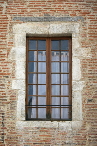 window of a brick building in cahors (france)