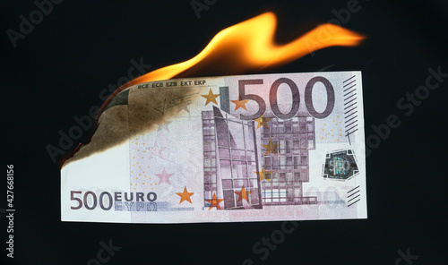 Five hundred Euros are burning with fire isolated on black