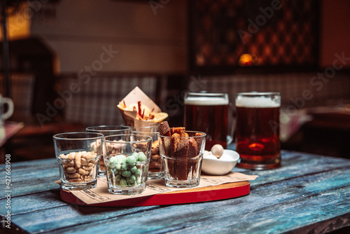 snacks to beer in glass glasses and two beers