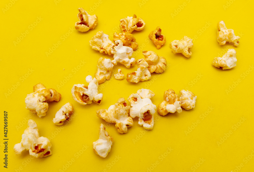 Close-up of popcorn on a yellow background. Close-up of popcorn on a yellow background.