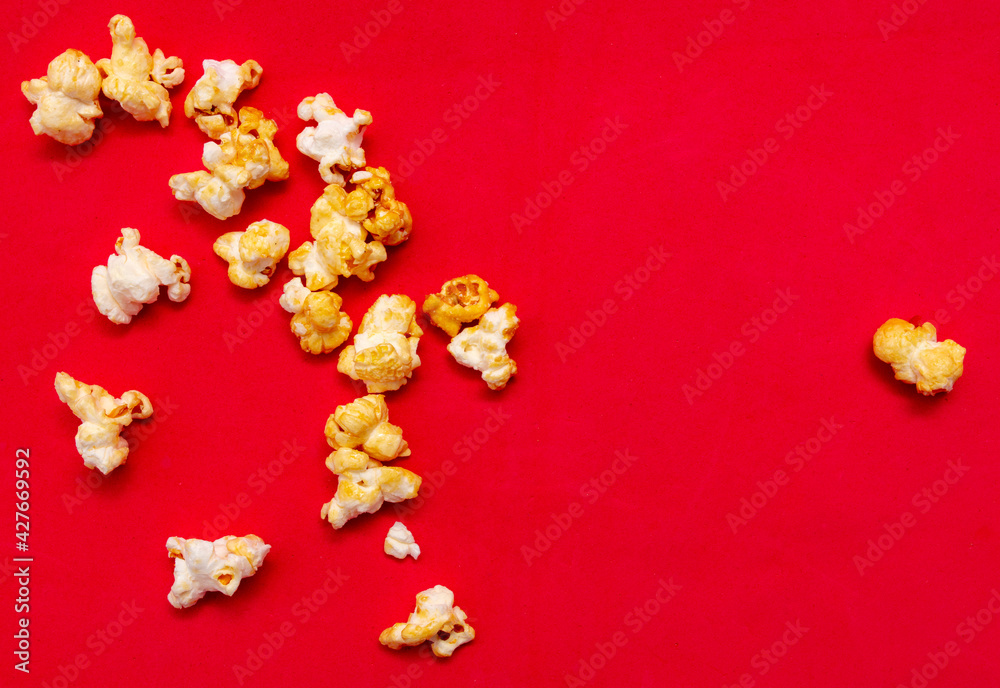 Close-up of popcorn on a red background. Close-up of popcorn on a red background.
