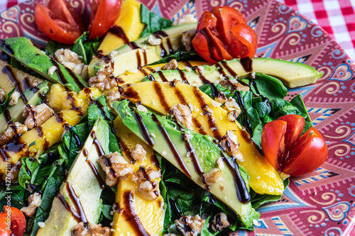 Close up of mango and avocado salad. Feeding background