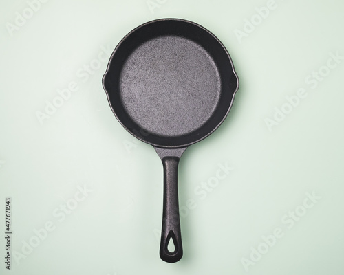 Empty Frying Pan on Light Green Background Top View Horizontal