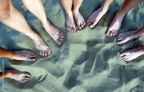 en feet of family of five on the sandy beach in summer © ChiccoDodiFC