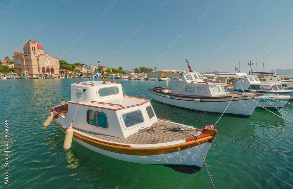 Port of charming Aegina town with yachts and fishermen boats docked in Aegina island, Saronic gulf, Greece, in a sunny summer morning