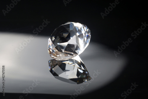 Excellent diamond of the first water with reflection on black mirror background close up view. Jewelry diamonds sale, invitation, action, discount banner, poster, card template with copy space