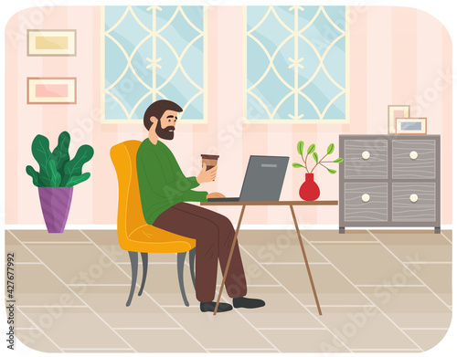 Bearded man with coffee sitting at table in room and correspondence surfing Internet work from home