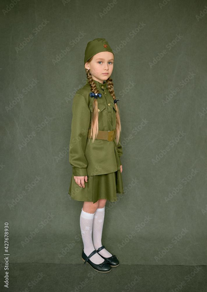 A little girl in a military uniform on May 9, Victory Day in Russia. A little girl in a military uniform on May 9, Victory Day in Russia.