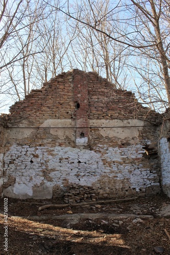 Inside of an old school building with just the sides. A small altar has been built by devil worshipers
