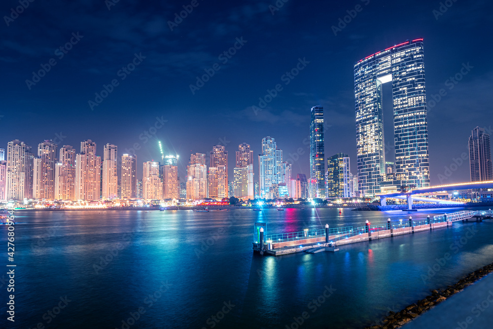 Fototapeta premium Numerous hotels and residential buildings and office business centers on the seashore in Dubai, United Arab Emirates. The concept of real estate prices and tourism