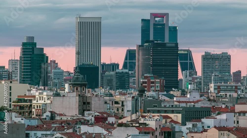 Madrid Skyline at sunset timelapse with some emblematic buildings and towers, part of the Cuatro Torres Business Area and also a side of Santiago Bernabeu Stadium. photo