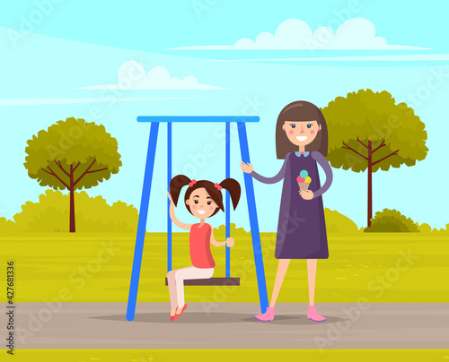 Woman walking with daughter girl swinging on slide swing at playing field outdoor family activities