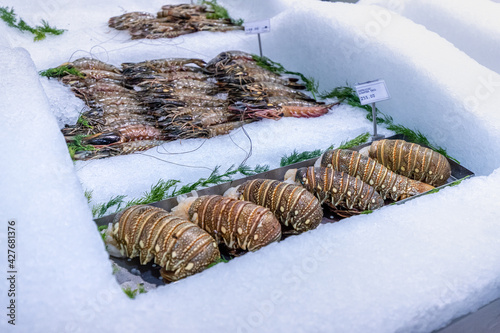 lobster tail on ice is sold in the seafood section of the supermarket