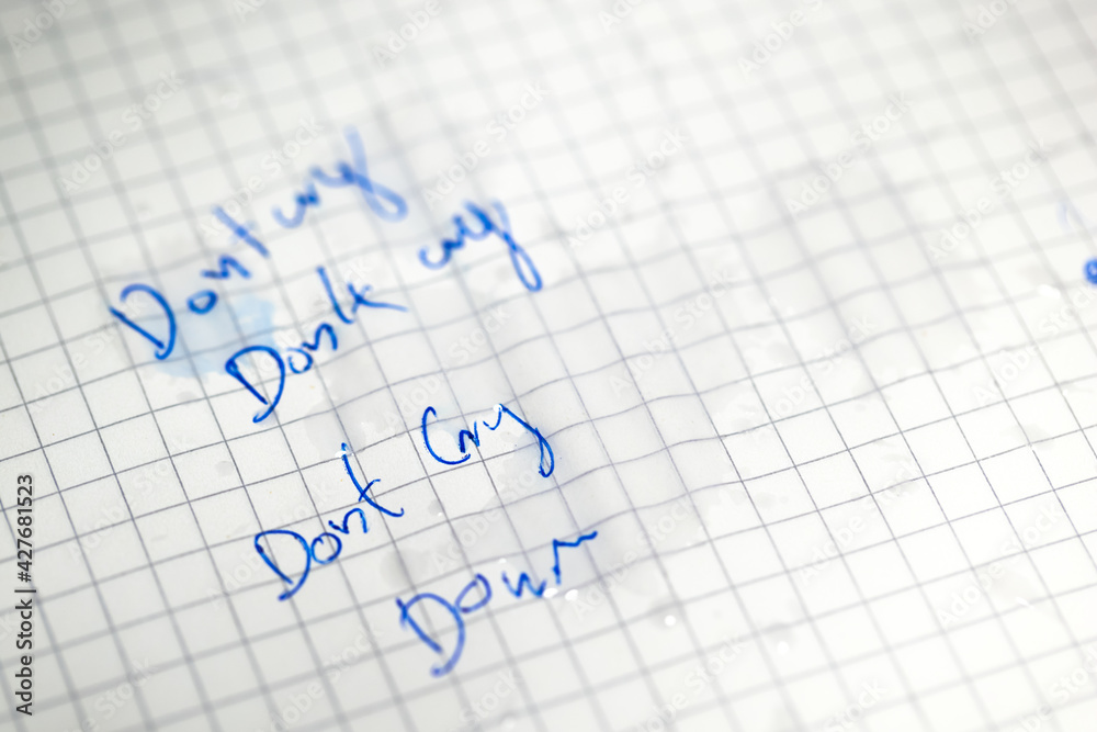 Tears on white paper with do not cry text Tears on white paper with do not cry text