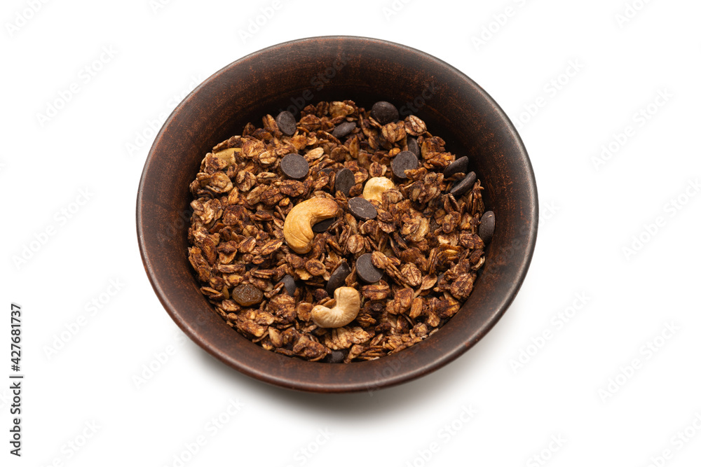 Chocolate granola cereal with nuts in a bowl background. Chocolate granola cereal with nuts in a bowl background.